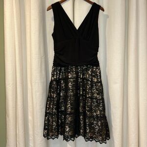 Black cocktail dress with nude illusion skirt.